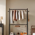 Modern Interior Floor Standing Clothes Rack With Hanging Sweaters And Small Hangers