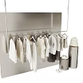 White Clothes Organized On Hangers With Silver Storage Bins And Light Colored Background