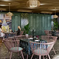 Thai Style Café Interior With Green Walls Hanging Lamps Wooden Chairs And Plants