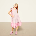 Man Wearing Pink Outfit Standing Against Light Background With Hands On Hips And Sandals
