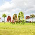 Vase with Red Yellow Orange Flowers in Green Meadow Under Cloudy Sky