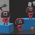 Toy Figures in Red Outfits With Square Circle Triangle Heads Standing on Blue Blocks
