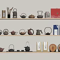 Assorted Teaware On Light Wooden Shelves With Teapots Jars Colorful Boxes And Tea Cakes