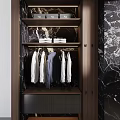 Modern Bathroom With Circular Mirror Wooden Cabinet Black Marble Walls And Countertop