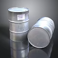 Silver Metal Drums Standing And Tilted With Label On Reflective Surface