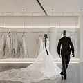 Modern Open Bridal Shop with Hanging Wedding Dresses Bride in Gown Groom in Suit Inside
