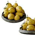 Fresh Yellow Pears in Black Bowl with Green Leaves on White Background