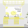 Yellow Checkout Counter With Smiley Faces Background Numbered Screens And Green Plant At MAYU HOME
