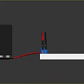 Black Power Supply Connected To White Circuit Board With Blue Component And Red Black Wires