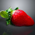 Juicy Fresh Red Strawberry With Green Leaves On Dark Reflective Surface
