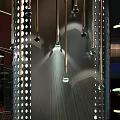 Hanging Chandeliers With Green Bulbs On Perforated Metal Panels And Light Shadow Effect