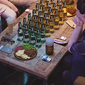 Public Chairs In Indoor Lounge Space With People Socializing Around Table And Drinks
