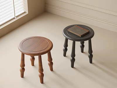 Two Round Brown And Black Wooden Stools In Light Room Corner With Book On Top 3d model