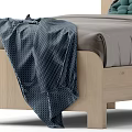 Single Bed with Wooden Frame Gray Sheets Blue Blanket Green Dark Pillows and Bedside Table