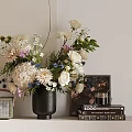 Beautiful Flower Arrangement In Black Vase With Books And Photo Frame