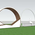Landscape Seat with Circular Arches and Lighting in Coastal Lawn at Dusk with Woman Sitting