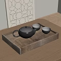 Black Teapot And Matching Cups In Wooden Tray On Wooden Table With Geometric Wall Art