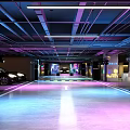 Modern Parking Garage With Colorful LED Lighting Sleek Ceiling And Reflective Floor