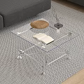 Clear Acrylic Coffee Table With Open Book Brown Cushion And Small Vase On Patterned Rug