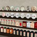 Traditional Tea Sets Display with Circular Tea Cakes Tea Boxes and Colorful Tins on Shelf