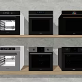 Kitchen Appliances Featuring Various Black And Gray Ovens Displayed On Shelves