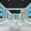 Modern Exhibition Hall Interior With Multiple Screens And White Circular Display Stand