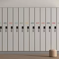 Row of White Numbered Wardrobes With Colorful Numbers Black Handles and Wooden Stool