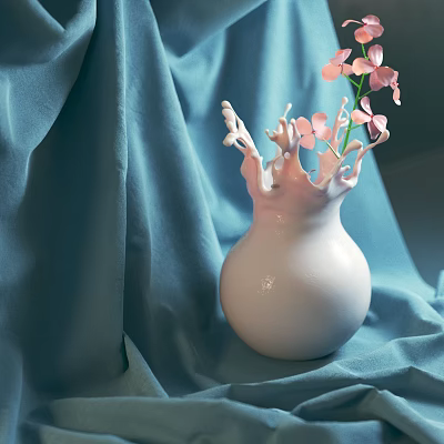White Vase With Milk Splash Design Holding Pink Small Flowers On Blue Cloth Background 3d model