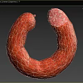 Red Curved Sausage With Sliced End Exposed Meat Texture On Black Background