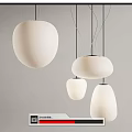 Modern White Pendant Lights With Various Shapes Hanging Against Gray Wall