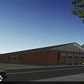 Red Brick Industrial Factory Building With Large Glass Windows Gray Roof And Surrounding Greenery