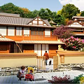 Traditional Ancient Architecture Exterior With Surrounding Green Trees And Colorful Floral Gardens