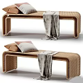 Modern Rattan Bench with Brown and Gray Pillows and Patterned Blanket for Cozy Seating