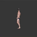 Shirtless Man Holding Kettlebell In Right Hand With Dark Underwear On Gray Background