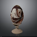Decorated Chocolate Egg With Red And White Marble Pattern And Gold Sprinkles On Wooden Stand