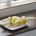 Fresh Peeled Banana on White Plate on Wooden Countertop Near Window