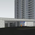Modern Residential Entrance Gate with High Rise Buildings Greenery and Driveway Lighting