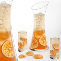 Refreshing Orange Beverage in Glass Pitcher and Cups with Ice Cubes Slices and Dried Flowers