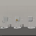 Three Toilets With Tanks Against Light Tiled Wall Middle Tank Yellow Pattern And Trash Bins