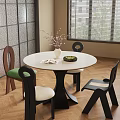 Round White Dining Table Set with Mixed Design Chairs Green White Cushions Vase and Book