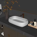 White Oval Washbasin with Golden Faucet on Dark Marble Counter and Toiletries in Modern Bathroom