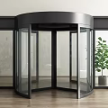 Modern Revolving Door With Black Frame Glass And Potted Plant On Wooden Floor