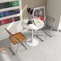 Round White Table with Two Orange Gray Transparent Chairs Metal Legs Interior with Vase Books