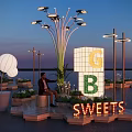 Outdoor Dessert Display Area With Illuminated SWEETS Sign Decorative Lights And Evening Sky Setting