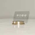 Transparent Acrylic Sign With Golden Base Displaying Please Do Not Touch Text