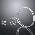 Silver Jewelry Set Including Large Hoop Earrings Small Hoops And Studs On Black Reflective Background