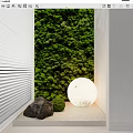 Green Wall Design With White Louvered Panels Stone Small Plants And Round Light