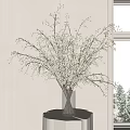 White Blossom Branches in Glass Vase on Table by Window With Snowy View