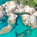 Natural Micro Terrain With Rocky Formations Clear Turquoise Water And Green Vegetation