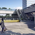 Outdoor Escalator In Modern Commercial Building With Glass Facade Steps And Greenery